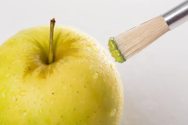 Maçã verde close-up com gotas de água sendo pintado em um b branco — Fotografia de Stock