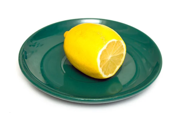 Lemon on a green plate — Stock Photo, Image