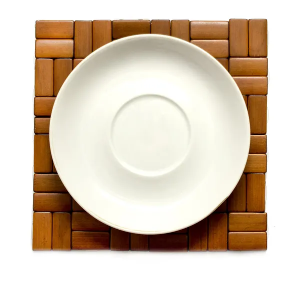 White plate on a wooden decorative background — Stock Photo, Image