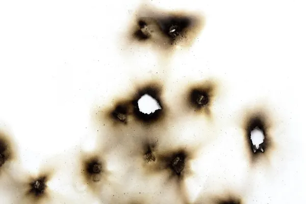 Bir kağıt parçası yanmış delikleri — Stok fotoğraf