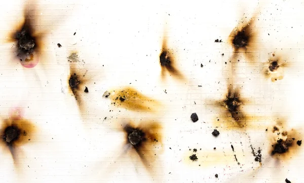 Brand hål i vitboken — Stockfoto