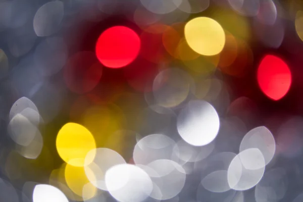 Vacaciones bokeh borrosa sobre un fondo oscuro — Foto de Stock