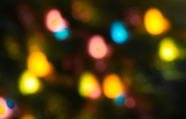 Holiday bokeh blurred on a dark background — Stock Photo, Image