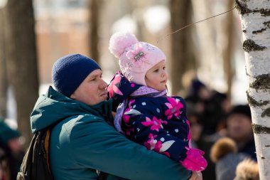 Petropavlovsk, Kazakistan - 06 Mart 2022: Kalabalıktaki çocuklara yakın çekim. Başla. Çocuklar gösteriyi izlemek için ailelerinin boynuna otururlar.