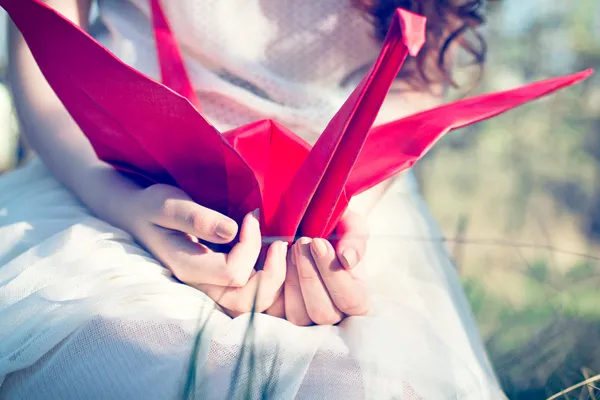 Girl with origami crane — Stock Photo, Image