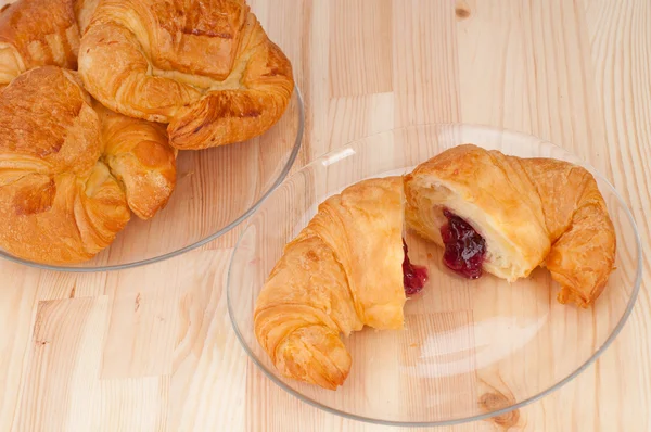 Croissant French brioche filled with berries jam — Stock Photo, Image
