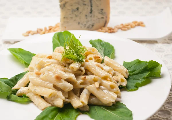 Italian pasta penne gorgonzola and pine nuts — Stock Photo, Image