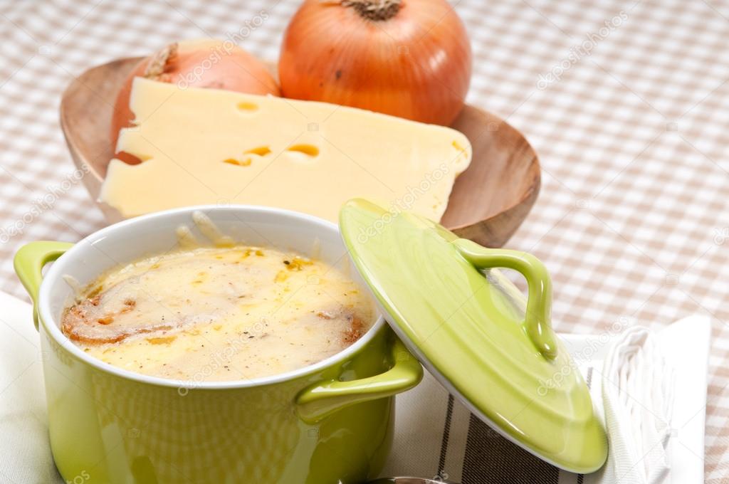 oinion soup with melted cheese and bread on top