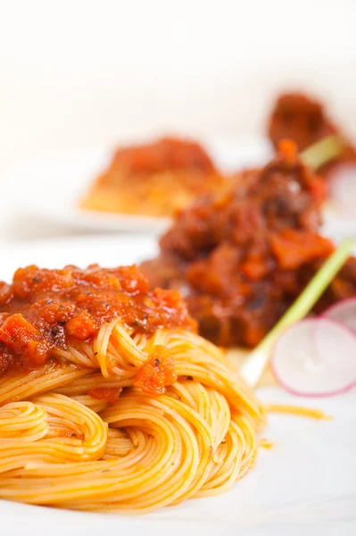 Pasta with pork ribbs sauce on polenta bed — Stock Photo, Image