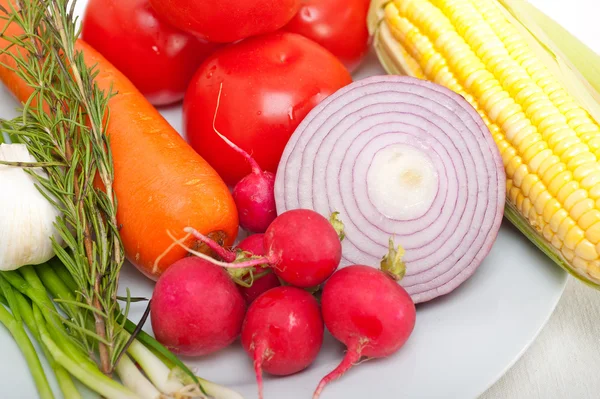 Fresh vegetables and herbs on a plate — Stock Photo, Image