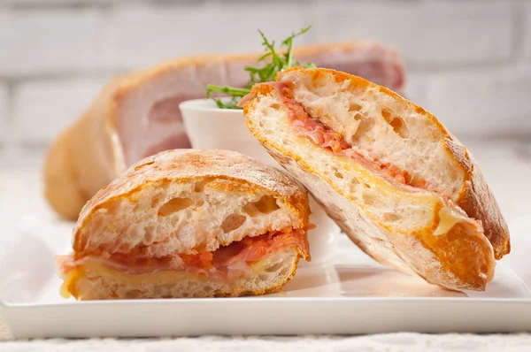 Ciabatta panini sandwich with parma ham and tomato — Stock Photo, Image