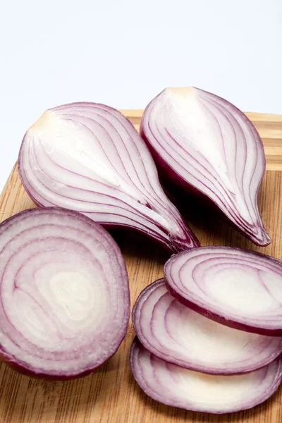 Red onions on a wooden board — Stock Photo, Image