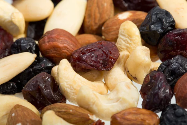 Mixed nuts and dried fruits isolated on white background — Stock Photo, Image