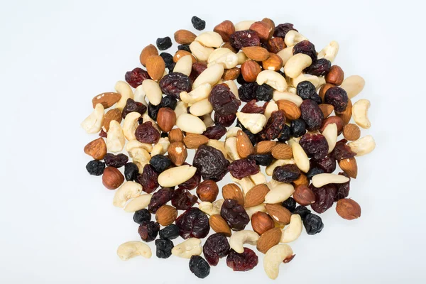 Mixed nuts and dried fruits isolated on white background — Stock Photo, Image