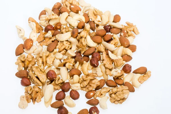 Bakgrund av blandade nötter - hasselnötter, valnötter, cashewnötter och pinjenötter — Stockfoto