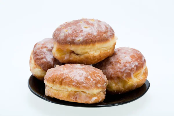 Whole donuts on the black porcelain plate — Stock Photo, Image