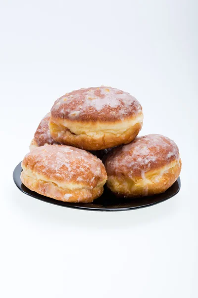 Whole donuts on the black porcelain plate — Stock Photo, Image