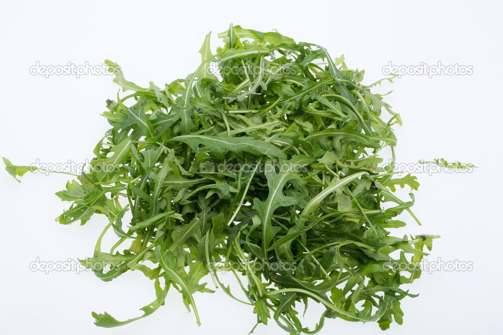 Heap of ruccola leaves isolated on white background