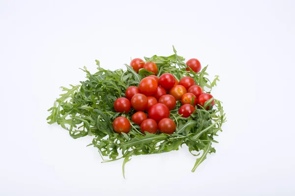 Heap of ruccola leaves and cherry tomatoes — Stock Photo, Image