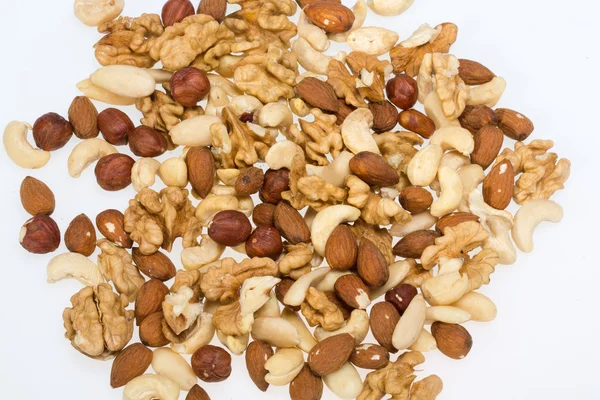Mixed nuts  -  hazelnuts, walnuts, cashews,  pine nuts isolated on white background — Stock Photo, Image