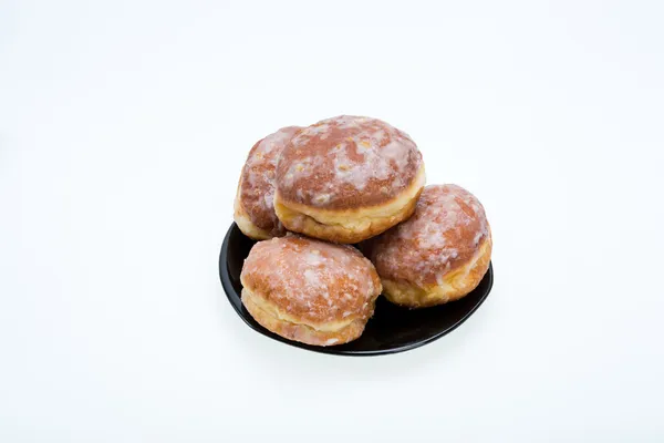 Whole donuts on the black porcelain plate — Stock Photo, Image
