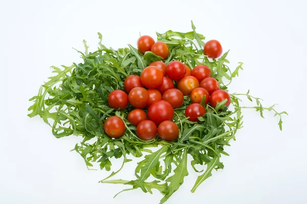 Heap of ruccola leaves and cherry tomatoes — Stock Photo, Image