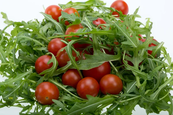 Heap of ruccola leaves and cherry tomatoes — Stock Photo, Image