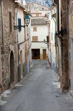 street with traditional house buildings, Pollenca town, Majorca island, Spain clipart