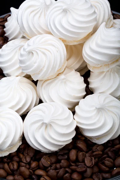 French vanilla meringue cookies and  coffee beans Royalty Free Stock Photos