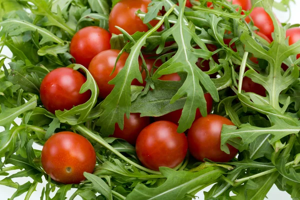 Heap of ruccola leaves and cherry tomatoes — Stock Photo, Image