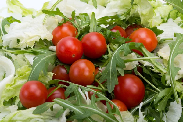 Montón de ruccola, hojas de lechuga y tomates cherry — Foto de Stock