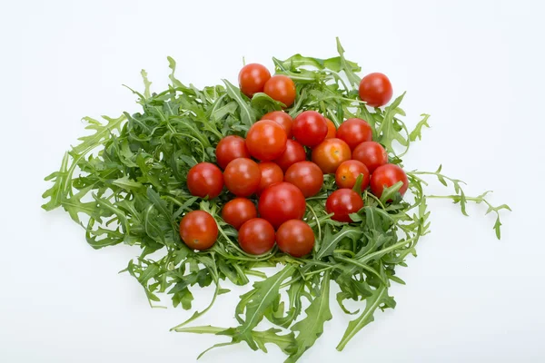 Heap of ruccola leaves and cherry tomatoes — Stock Photo, Image