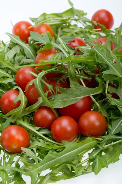 Heap of ruccola leaves and cherry tomatoes — Stock Photo, Image