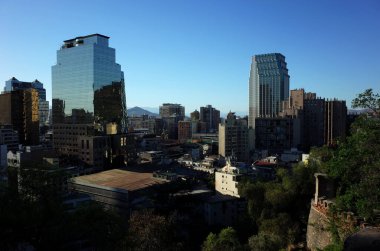 Santiago, Şili - 24 Kasım 2018: Şehir merkezinin modern binaları Santa Lucia Hill 'den izlendi, fotoğraf güneşe karşı çekildi