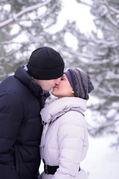 Портрет молодой красивой пары, целующейся на улице зимой — стоковое фото
