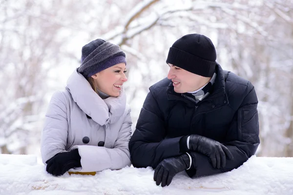 Portrait of a Young Smiling Couple Lying on the Snow — Stock Photo, Image