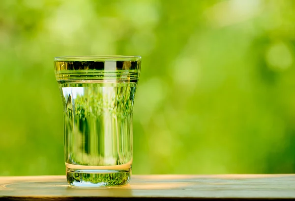 Glass Full of Water against the Green Nature Background — Stock Photo, Image