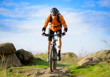 Cyclist Riding the Bike on the Beautiful Mountain Trail clipart