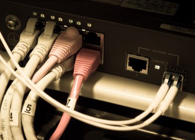 UTP Network cables connected to an Fast-Giga ethernet ports clipart