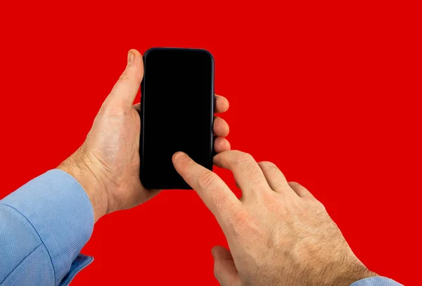 Man Hand Shirt Holding Smartphone Studio Shot Red Background — стоковое фото