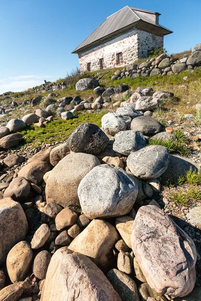 Stone house on the rocky shore. — Stock Photo, Image