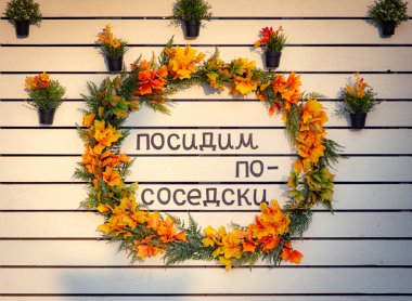 Çiçekli kompozisyon ve not: burada komşular gibi oturalım