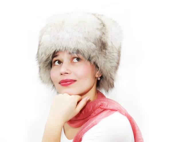 Attractive girl wearing white fur hat looking up and left isolated on white — Stock Photo, Image