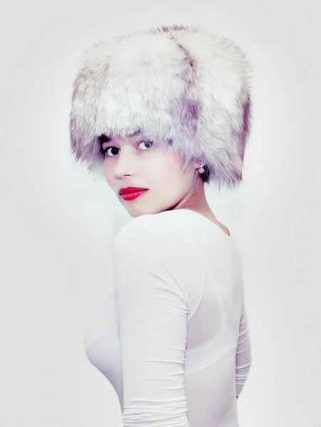 Attractive girl wearing white fur hat isolated on white — Stock Photo, Image