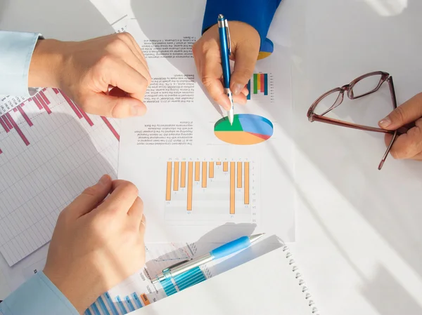 Image of male hand pointing at business document during discussion at meeting — Stock Photo, Image