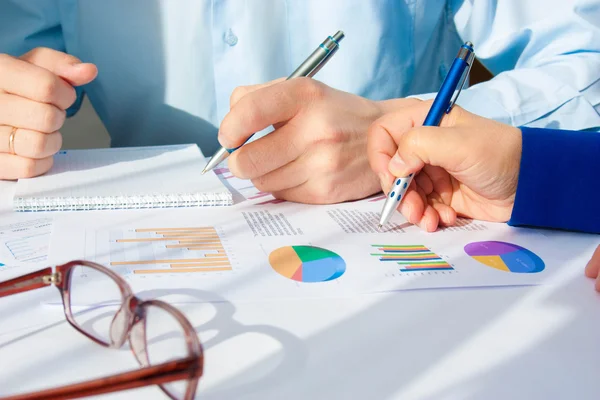 Image of male hand pointing at business document during discussion at meeting — Stock Photo, Image