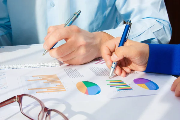 Image of male hand pointing at business document during discussion at meeting — Stock Photo, Image