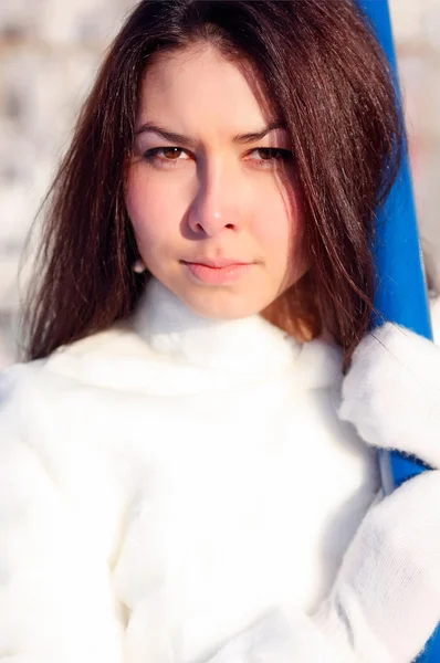 Beautiful girl with long hair in a white fur coat — Stock Photo, Image