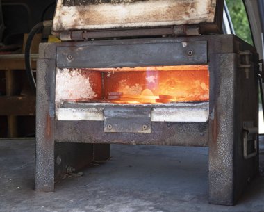 Farrier with horse hoof working close up