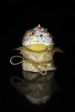 Karanlık arka planda paskalya pastası. Kağıda sarılmış bir halatla.